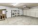Spacious two-car garage with ample storage, shelving, and an automatic overhead door at 15619 N 58Th Ave, Glendale, AZ 85306