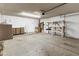 Attached two-car garage with workbench, shelves, and overhead door at 15619 N 58Th Ave, Glendale, AZ 85306