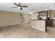 Open concept kitchen featuring a breakfast bar, pendant lights and stainless steel appliances at 15619 N 58Th Ave, Glendale, AZ 85306