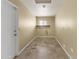 Bright and functional laundry room with tile flooring and built-in shelf at 15619 N 58Th Ave, Glendale, AZ 85306