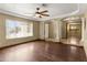 Inviting living room with a ceiling fan, hardwood floors and decorative columns at 15619 N 58Th Ave, Glendale, AZ 85306