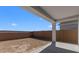 Backyard features a covered patio area, offering shade and a view of the perimeter wall at 16575 N Lunar St, Maricopa, AZ 85138