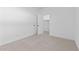 A bright bedroom with neutral carpet and white trim, and a closet with an open door at 16575 N Lunar St, Maricopa, AZ 85138