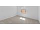 Empty bedroom with neutral carpet, white trim, and a window with blinds at 16575 N Lunar St, Maricopa, AZ 85138