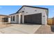 This home features a two car garage, stylish modern farmhouse design, and a clean driveway at 16575 N Lunar St, Maricopa, AZ 85138