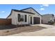 Beautiful single-story home with a well-manicured front yard, dark shutters, and a two-car garage at 16575 N Lunar St, Maricopa, AZ 85138