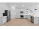 Modern kitchen features stainless steel appliances, ample counter space, and bright white cabinets at 16575 N Lunar St, Maricopa, AZ 85138