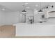 Bright, modern kitchen with stainless steel appliances, a large island, and pendant lighting at 16575 N Lunar St, Maricopa, AZ 85138