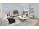 Cozy living room featuring bright windows, stylish seating, and a contemporary design with a light-colored palette at 16575 N Lunar St, Maricopa, AZ 85138
