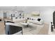 Open living space with modern white furniture, a stylish rug, and an eat-in kitchen at 16575 N Lunar St, Maricopa, AZ 85138
