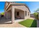 A covered patio area with pavers and artificial grass creates an inviting outdoor space at 1677 W Seagull Ct, Chandler, AZ 85286