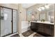 Bathroom features a glass shower, soaking tub, double vanity, and tile flooring at 1677 W Seagull Ct, Chandler, AZ 85286