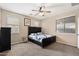 Cozy bedroom with carpet, a ceiling fan, and natural lighting from the windows at 1677 W Seagull Ct, Chandler, AZ 85286