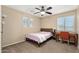 Cozy bedroom with bed, desk, and natural light for relaxation and productivity at 1677 W Seagull Ct, Chandler, AZ 85286