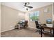 Office/bedroom features carpet, a ceiling fan, window and two work spaces at 1677 W Seagull Ct, Chandler, AZ 85286