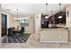 Bright dining area with a modern chandelier, and sleek black dining set next to kitchen at 1677 W Seagull Ct, Chandler, AZ 85286