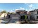 Two-story home featuring a front-facing garage, neutral paint and desert landscaping at 1677 W Seagull Ct, Chandler, AZ 85286