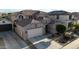 Exterior elevation of a two-story home featuring a front-facing garage, neutral paint and desert landscaping at 1677 W Seagull Ct, Chandler, AZ 85286