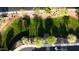 Aerial view of a lush front yard with green grass, landscaped garden beds, and a sprinkler system at 1677 W Seagull Ct, Chandler, AZ 85286