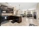 Kitchen flows into the living area with granite countertops, dark cabinets and tile floors at 1677 W Seagull Ct, Chandler, AZ 85286