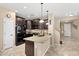 Open kitchen with dark cabinetry, granite countertops, and stainless steel appliances at 1677 W Seagull Ct, Chandler, AZ 85286
