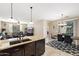 Modern kitchen with granite countertops and adjoining dining and living spaces at 1677 W Seagull Ct, Chandler, AZ 85286