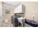 Functional laundry room with machines, storage, and utility sink for convenient chores at 1677 W Seagull Ct, Chandler, AZ 85286