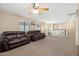 Expansive living area featuring plush sofas, ceiling fan, and well-lit atmosphere at 1677 W Seagull Ct, Chandler, AZ 85286
