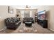 Relaxing living room featuring leather seating, carpet, and a decorative area rug at 1677 W Seagull Ct, Chandler, AZ 85286
