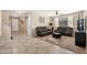 Comfortable living room with plush leather seating, a ceiling fan, and a neutral color palette at 1677 W Seagull Ct, Chandler, AZ 85286