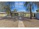Backyard showing mature trees and a path leading to the home at 1719 E Pinchot Ave, Phoenix, AZ 85016