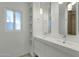 Modern bathroom featuring double sinks, pendant lights, and a tiled shower in a bright space at 1719 E Pinchot Ave, Phoenix, AZ 85016