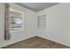 Cozy bedroom featuring wood floors, built-in shelves, and a window for natural light at 1719 E Pinchot Ave, Phoenix, AZ 85016