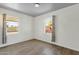 Bright bedroom featuring hardwood floors and two windows offering plenty of natural light at 1719 E Pinchot Ave, Phoenix, AZ 85016
