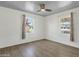 Bedroom with neutral walls, ceiling fan, and two windows providing natural light at 1719 E Pinchot Ave, Phoenix, AZ 85016