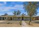 Charming home with a covered front porch, large trees and desert landscaping at 1719 E Pinchot Ave, Phoenix, AZ 85016