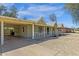 Exterior view of house featuring a carport, desert landscaping, and vintage architectural details at 1719 E Pinchot Ave, Phoenix, AZ 85016