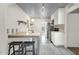 Bright kitchen featuring stainless steel appliances, open shelving, bar seating, and stylish tile flooring at 1719 E Pinchot Ave, Phoenix, AZ 85016