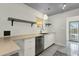 Bright kitchen with stainless steel dishwasher, countertop seating, and open shelving at 1719 E Pinchot Ave, Phoenix, AZ 85016