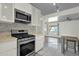 Kitchen featuring stainless steel gas range, microwave, and open floorplan view at 1719 E Pinchot Ave, Phoenix, AZ 85016