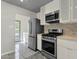 Kitchen with stainless steel appliances, including refrigerator, gas range, and stylish backsplash at 1719 E Pinchot Ave, Phoenix, AZ 85016