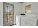 Laundry room with washer, dryer, and access to the outdoors at 1719 E Pinchot Ave, Phoenix, AZ 85016