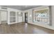 Living room featuring wood flooring, natural light, and access to the front porch at 1719 E Pinchot Ave, Phoenix, AZ 85016