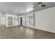 Bright living room with hardwood floors, a ceiling fan, and built-in shelving at 1719 E Pinchot Ave, Phoenix, AZ 85016