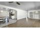 View of kitchen and living room with hardwood floors, white cabinets and stainless steel appliances at 1719 E Pinchot Ave, Phoenix, AZ 85016