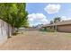 Open backyard with ample space, storage shed, and partial view of the house at 1750 W Mohawk Ln, Phoenix, AZ 85027