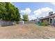 Open backyard featuring a shed, block fence, grass and gravel landscaping, plus mature trees at 1750 W Mohawk Ln, Phoenix, AZ 85027