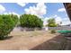 Spacious backyard with block fence, grass and gravel landscaping, and storage shed at 1750 W Mohawk Ln, Phoenix, AZ 85027