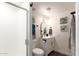 Bathroom features wood look flooring, tiled shower with glass and updated vanity at 1750 W Mohawk Ln, Phoenix, AZ 85027