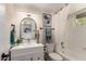 Bright bathroom features a bathtub with shower and framed round mirror at 1750 W Mohawk Ln, Phoenix, AZ 85027